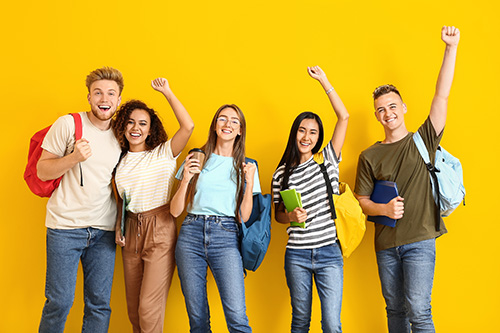 Group of happy students on color background